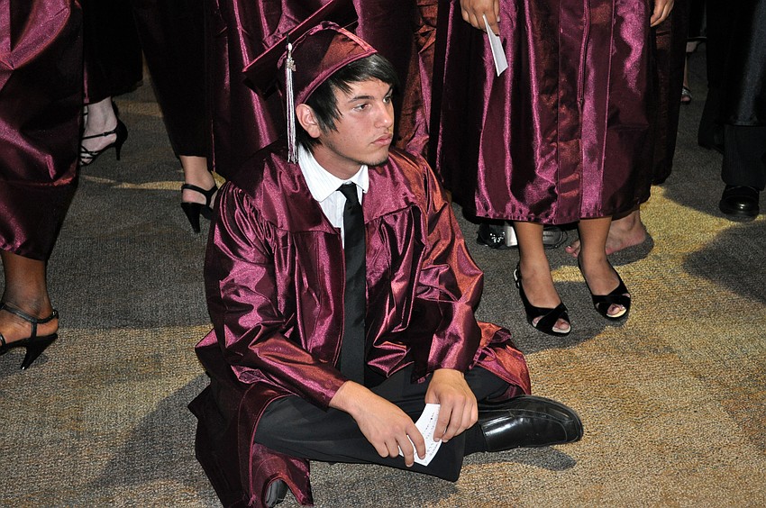 Eighteen-year-old Lucas Vasconcellos got comfortable while waiting for the procession to start.