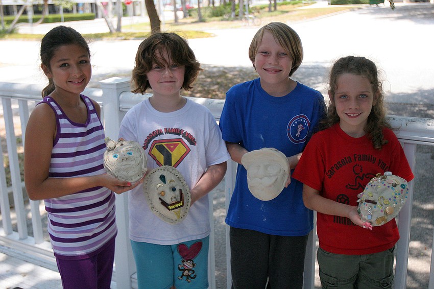 Mira Kumar, Catherine Anderson, Colin Schoening and Claire Halflants show off the masks they made in their It's All Greek To Me! summer art class at Art Center Sarasota.