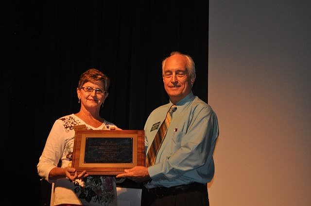 Ginya Carnahan, Dattoli Cancer Center, accepts the '11 or more employees' category award from Dennis Hassell.