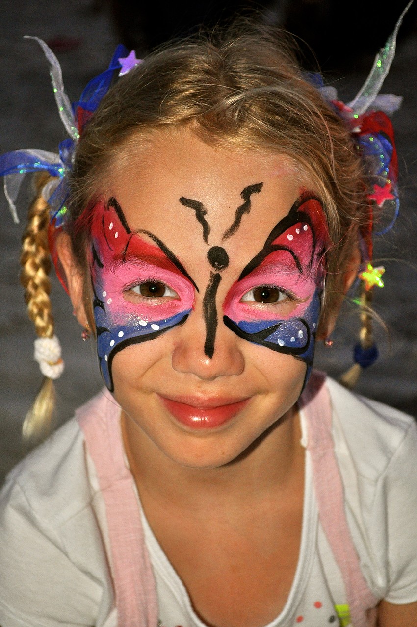Ashley Olson shows off her face paint art.