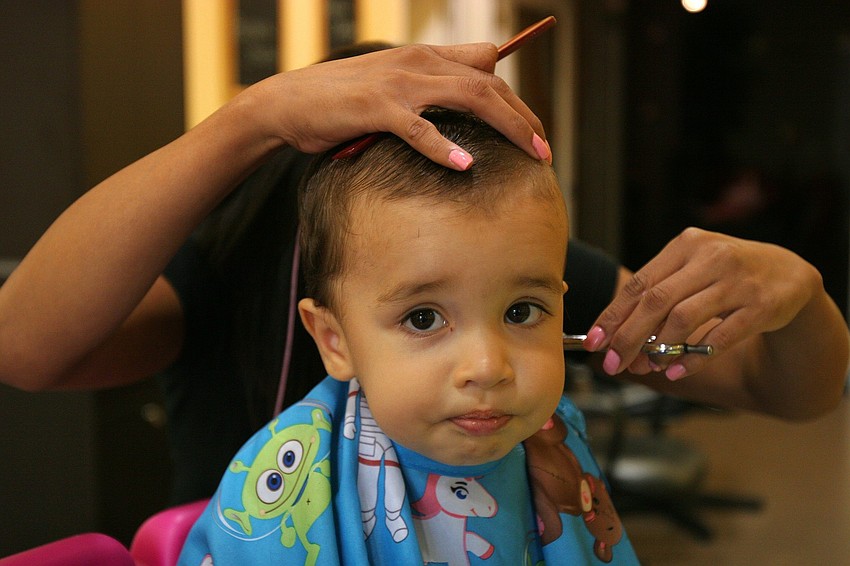 Reid Sokol, 1 years-old, gets his first hair cut by Gladis Santana Monday, June 13 at Lilâ€™ Divas and Dudes.