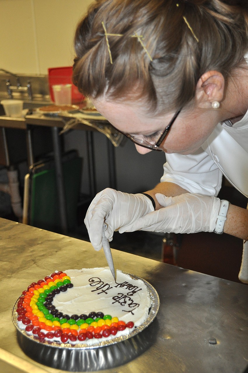 Chef Sarah Cooper decorates a brownie.