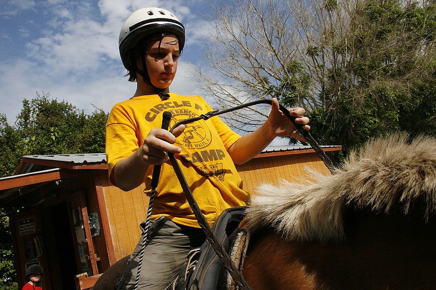 Galen Rudd, 10, loves trotting around the arena.