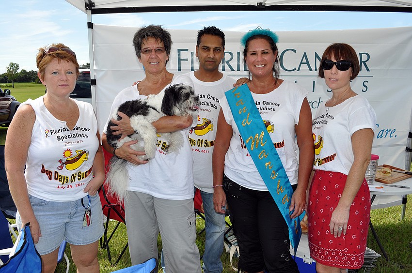 Marti Ryan, Deb Martin, holding her dog Ben, Vivek Gupta, Kelly duHamel and Traci Seeley of Florida Cancer Specialists