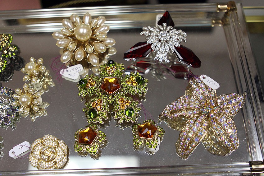 Baci broaches and earrings were up at the jewelry counter by some of the more expensive jewelry Friday, July 22 at the estate sale.