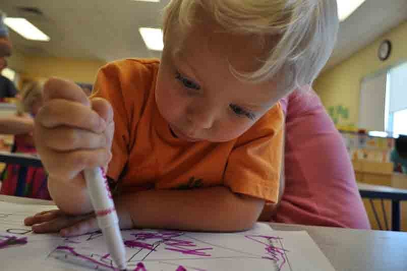 Liam Christenson, 2, was intent on drawing.