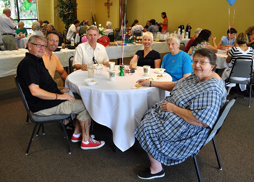 Tom Bisker, Bill Wood, Rich Swastek, Martha Huie, Oriole Hart and Becky Westbrook enjoy their ice cream Sunday, August 14 during the ice cream social in the Parish Hall at St. Boniface.