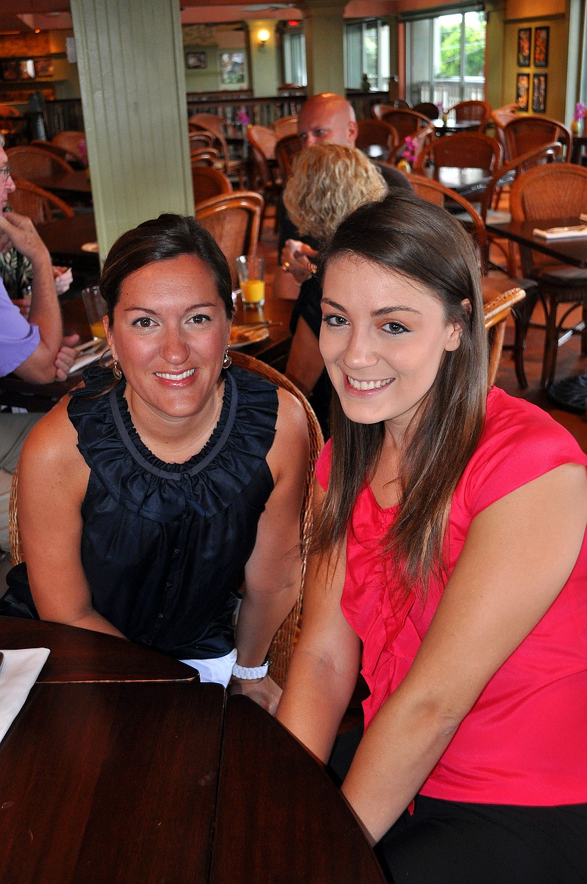 Stacy Alexander and Amanda Rondosh pose together Tuesday, Aug., 16 at Tommy Bahama Restaurant.