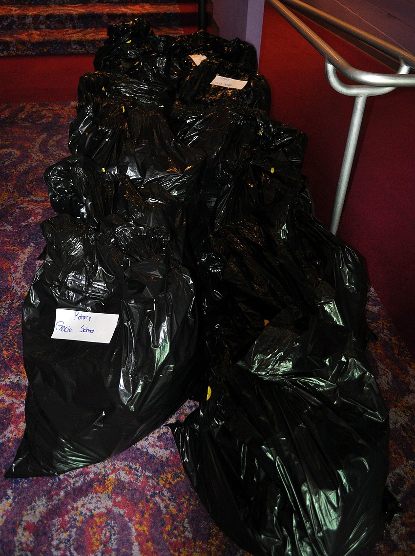 Garbage bags with supplied backpacks were piled up off in the corner.