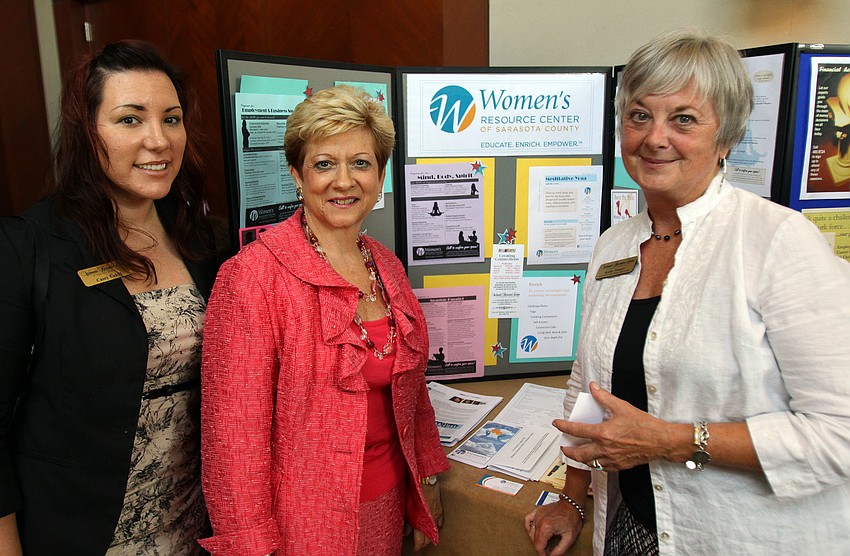 Casey Cahill, Executive Director Janice Zarro and Kathy Powers pose in front of their display table for the Womenâ€™s Resource Center of Sarasota Saturday, Aug. 20 at the Hyatt Regency Sarasota.