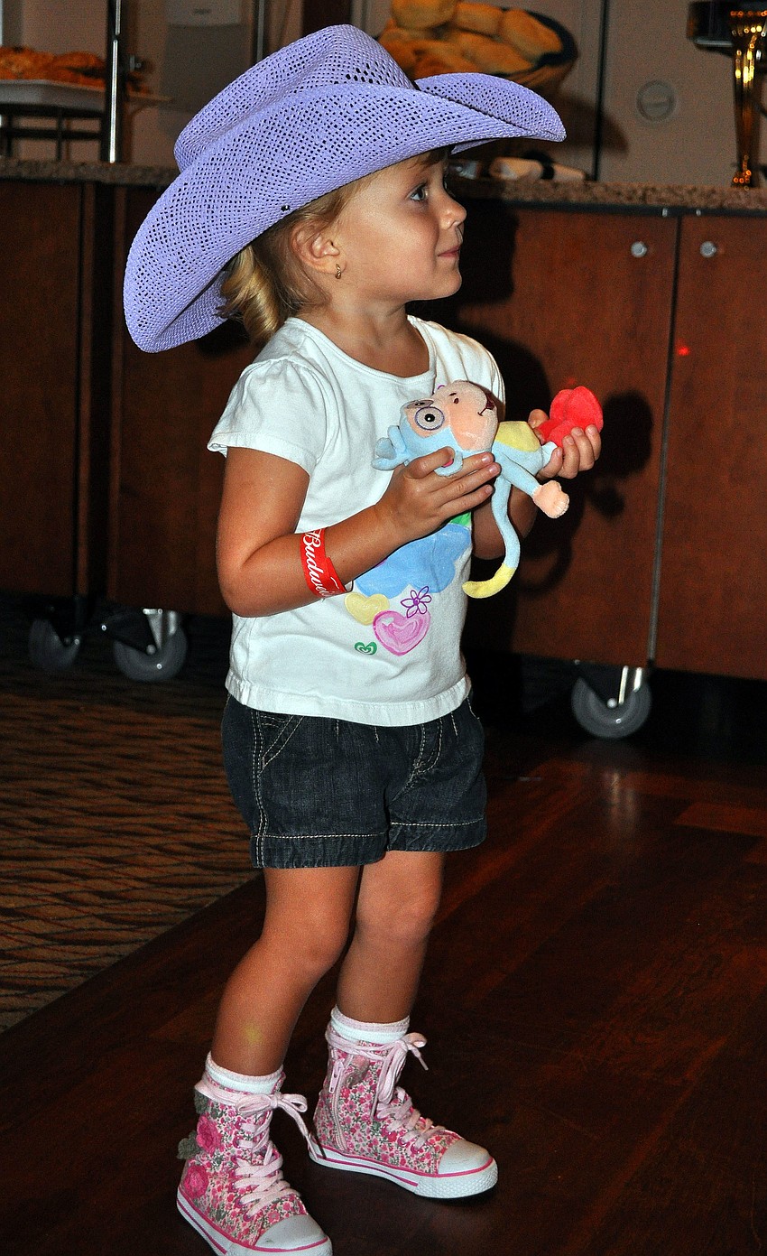 Frankie Bersch, 2, wears a cowboy hat and bounces around to the music Saturday, Aug. 20 at the Sarasota Yacht Club.