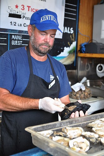 Dan Smith shucks oysters. PHOTOS BY SHANNA FORTIER