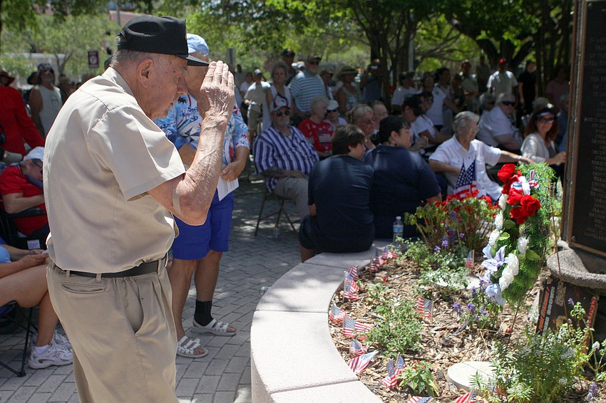 A.M.M.V. Harold Cueman salutes the American Merchant Marine wreath he laid Monday, May 30 at the Honoring Our Fallen Heroes Memorial Day ceremony that took place following the parade.