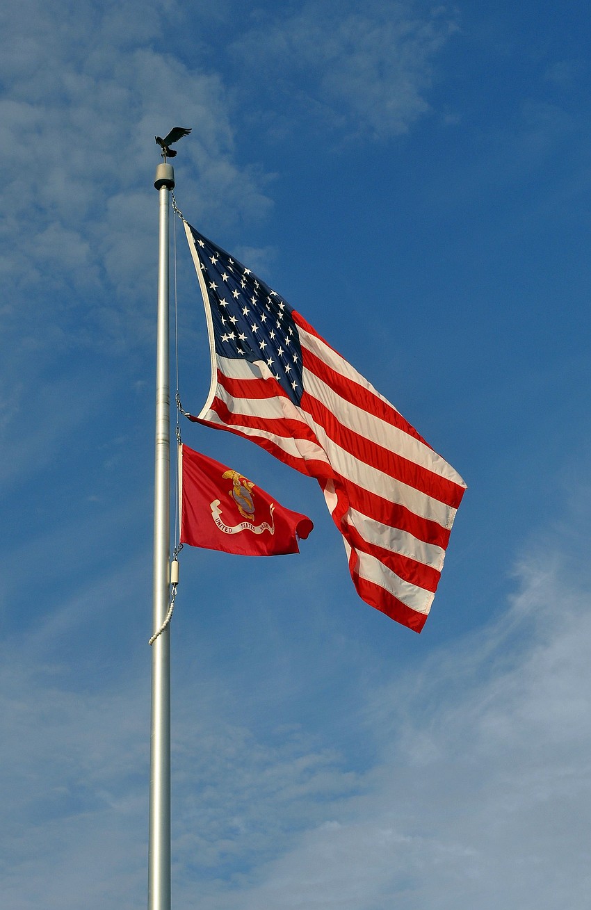 The American flag and the flag for the United States Marine Corps fly high at the Gold Coast Eagle Distributing facility out in Lakewood Ranch.