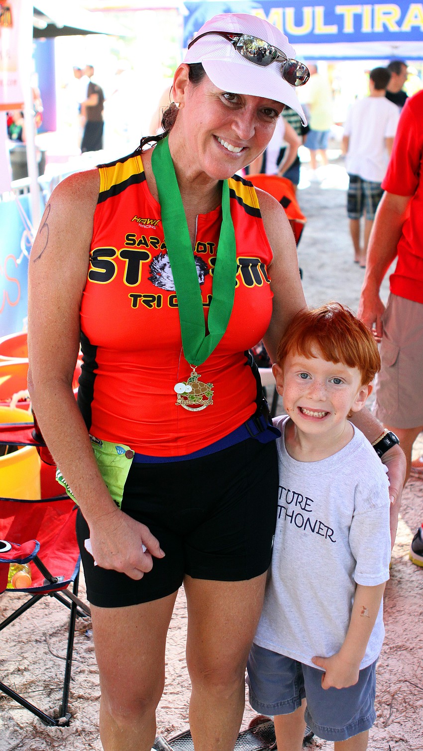 Lisa Brewer poses with her nephew, Cooper Schrock, 5, who ran the last few feet of the triathlon with Brewer.