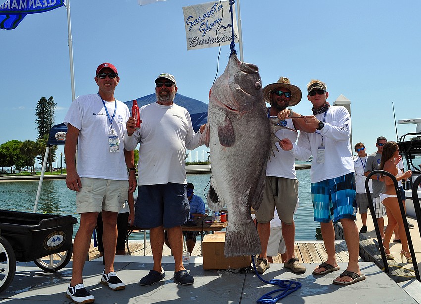 Team Bragginâ€™ Rites poses with their 181.85 lbs. Warsaw grouper.