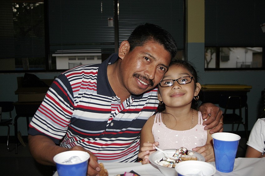 Five-year-old Bridgett Gomez took a break from dancing to enjoy an ice cream sundae with her father, Santos.