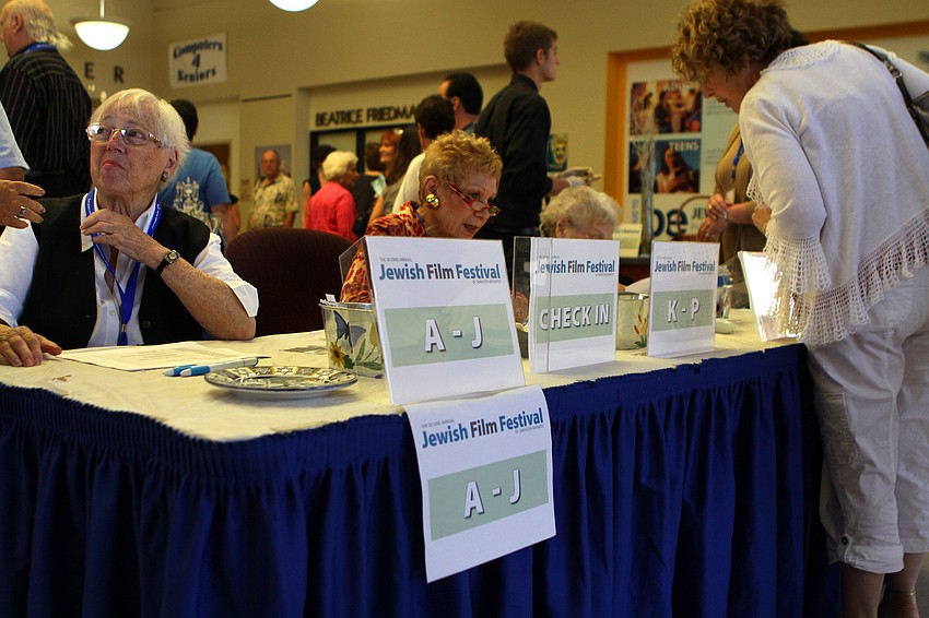 Volunteers help people to buy and pick up their tickets on Sunday, March 27 during the opening reception for the second annual Jewish Film Festival that took place at the Beatrice Friedman Theatre on the Jewish Community Campus.