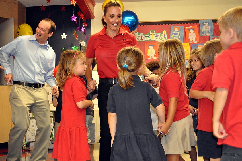 Primrose School owner Sharon Frank and a handful of kindergartners dance in celebration of the Phayre family.