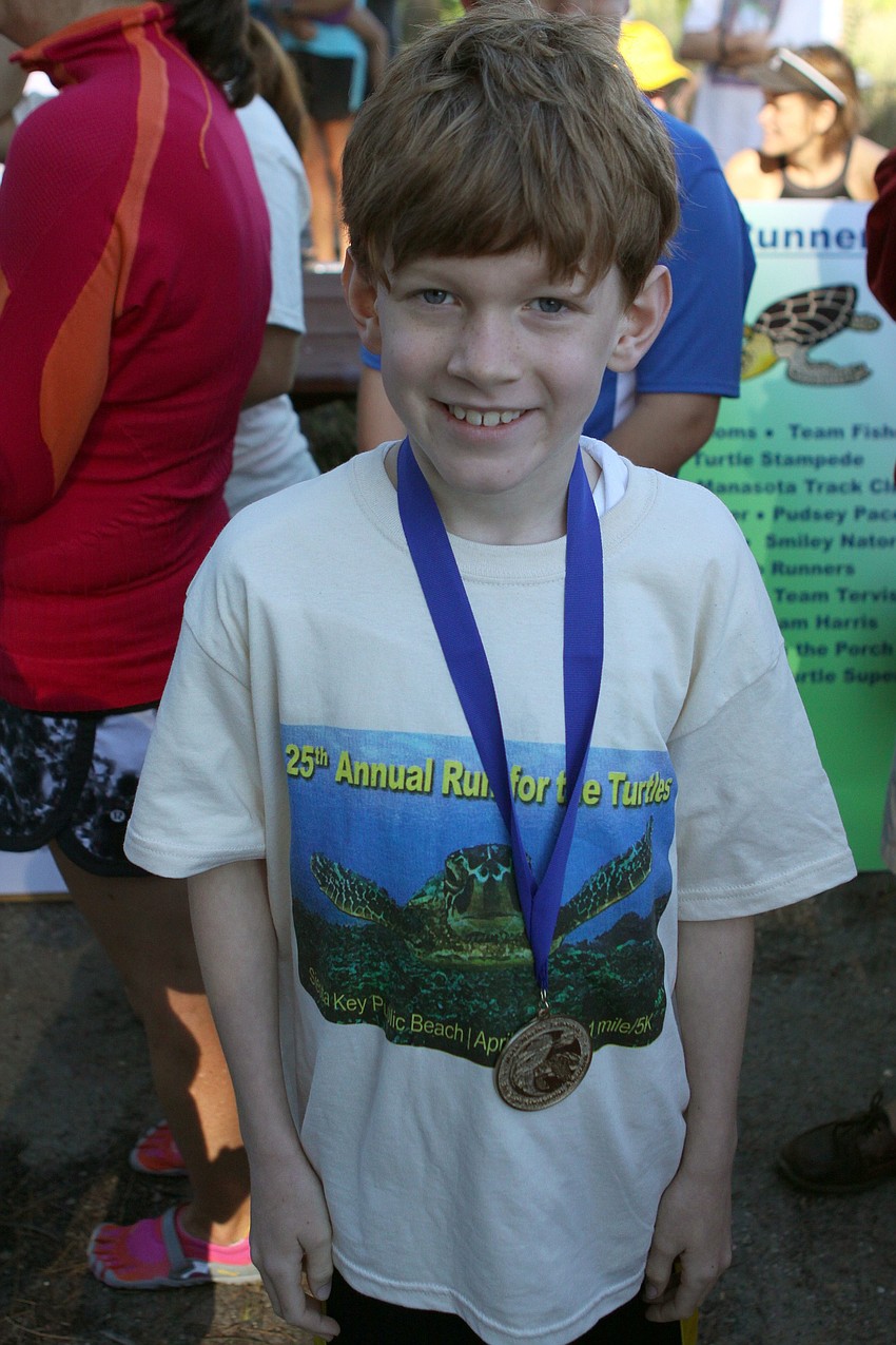 Russell Gokemeijer, 8, won first place in his age group for boys on Saturday, April 2 for the 25th Annual Run for the Turtles on Siesta Key Beach.