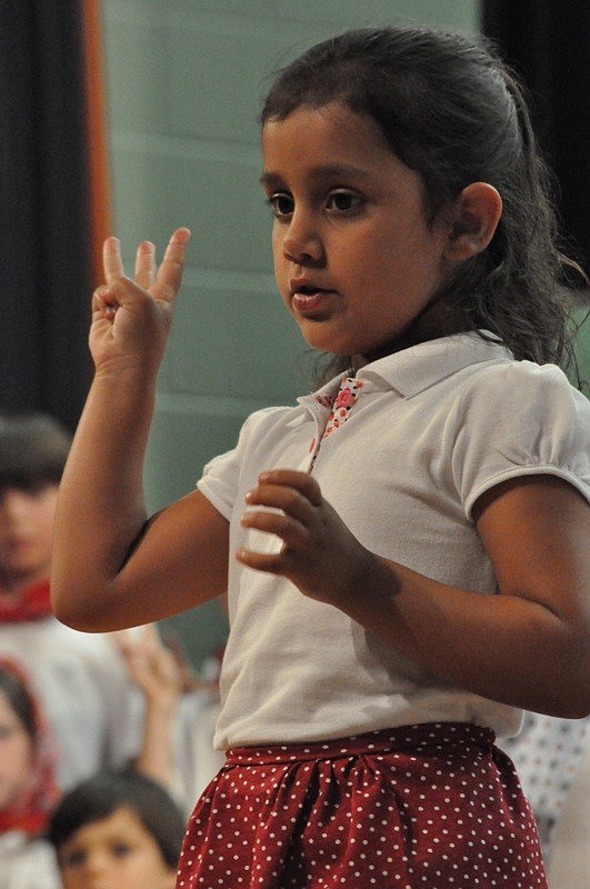 Alessandra Caamano villager counts the three round stones.