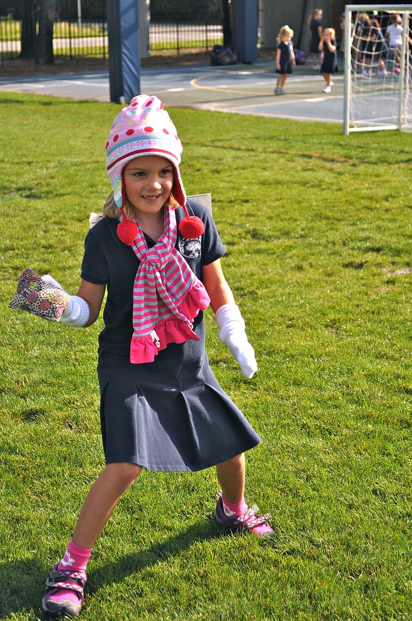 Madeline Frazier prepares to toss a beanbag to her opponent.