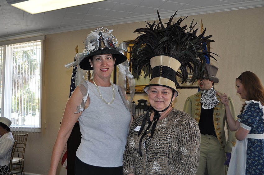 Cynthia Soulandros and DAR Sara DeSoto Chapter Regent, Rebecca Morgan, who created her unique hat using feathers and a lampshade.