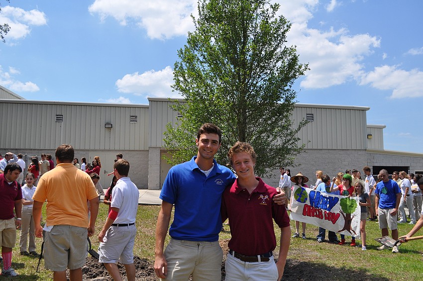 Jimmy Valenti and Nick Kelly pose with the school's Arbor Day tree.
