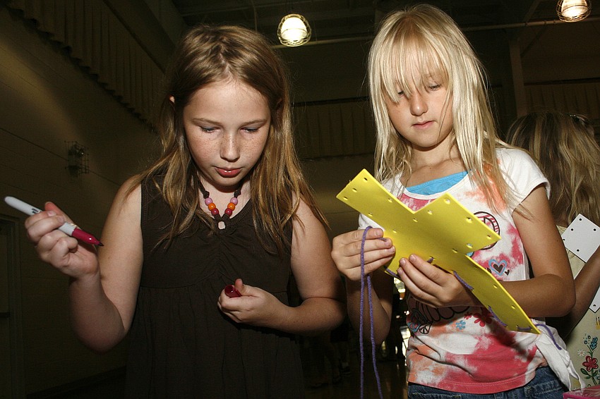 Alasia Gray, 10, and Olivia Henderson, 6, worked hard on their cross art projects.