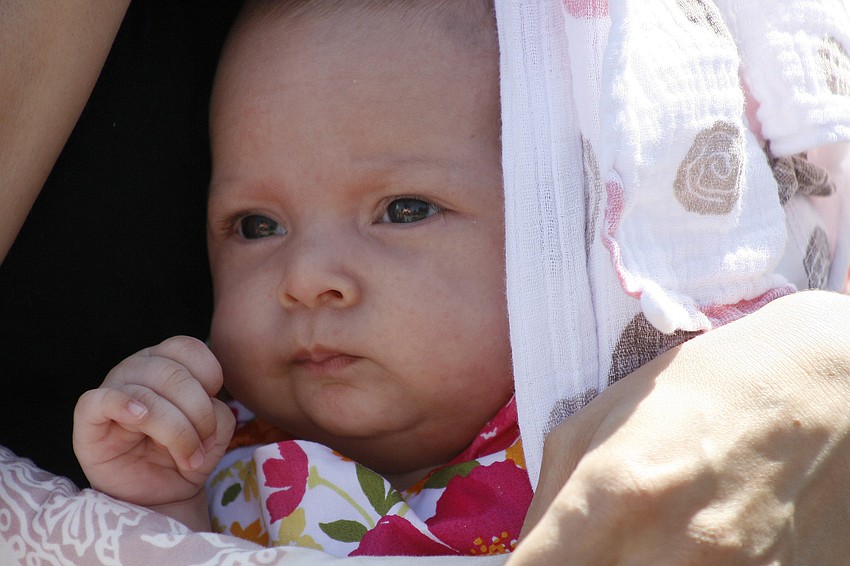 Cora Tobata, 10 weeks, celebrated her first Easter wrapped up close to her mom.