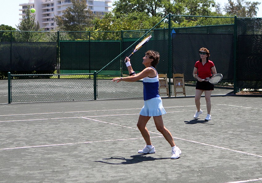 Jeanne Brown goes for the volley during her doubles match Friday, April 22 during the Lunch Bunch All-Star Children's Foundation fundraiser at the Longboat Key Club Tennis Gardens.