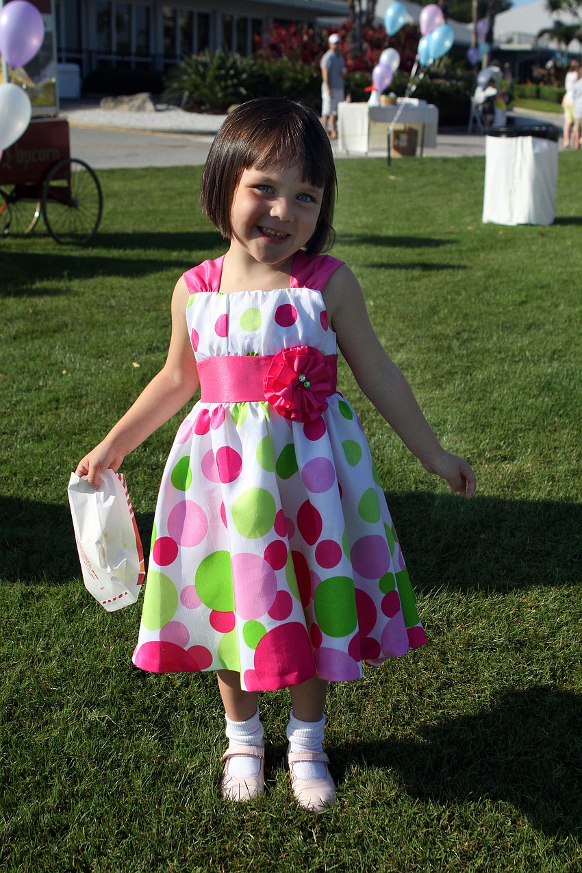 Sloane Patrick, 3, shows off her pink and green Easter dress Sunday, April 24 at the Longboat Key Club Easter egg hunt.