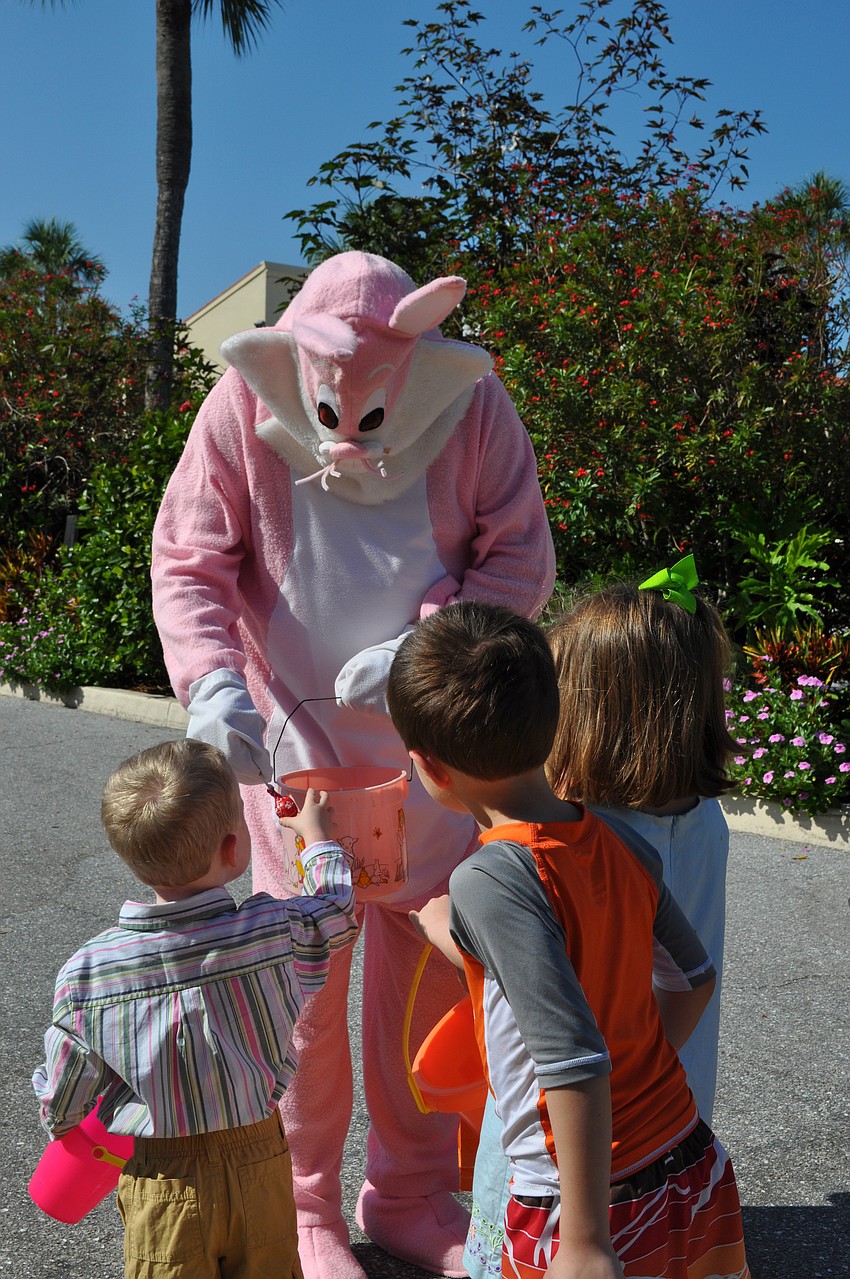 The Easter Bunny (Ed Ryan Jr.) has candy for the eager youngsters.