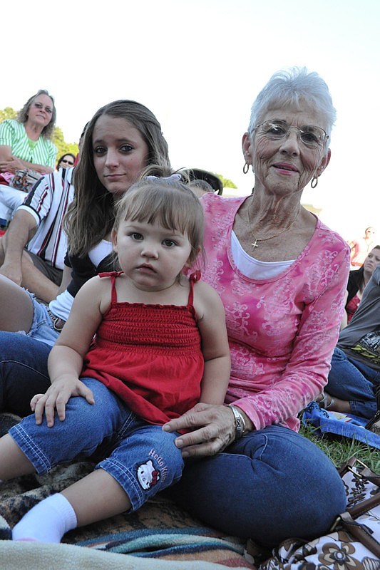 Lynda Cole, right, with Cassie Saletnik and Madison Coombs, 1, came to see her other foster children perform.