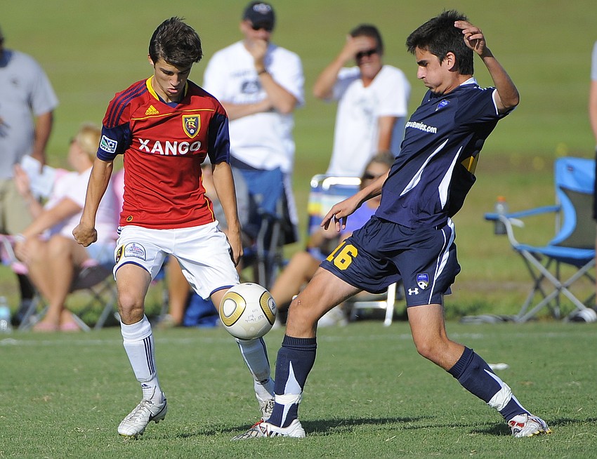 RSL Florida's Kyle Apperson and IMG Soccer Academy's Jean Samara battle for the ball.