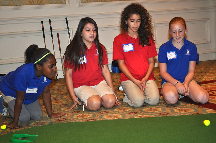 Derrian Gobourne, Montserrat Leon, Naiomi Ortiz and Samantha Keesecker watch their classmate make a putt.