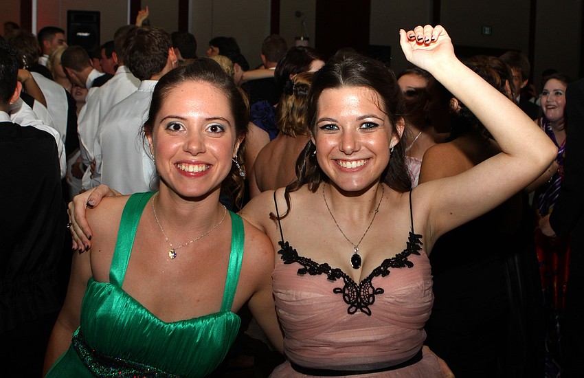 Esen Barut and Olivia Swenson make their way back to the dance floor Saturday, May 14 at the Sarasota High School's prom at the Hyatt Regency.