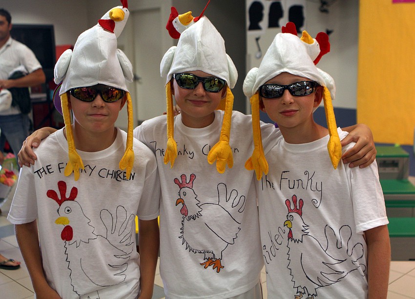 Andrew Winton-Burnett, William Jorgensen and Ricky Cusolito pose in their chicken costumes prior to performing Wednesday, May 25 in the Phillippi Shores 