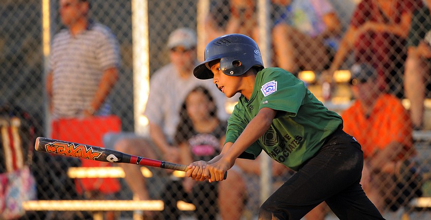 Twelve-year-old Cobe Hutchison attempts to lay down a perfect bunt.