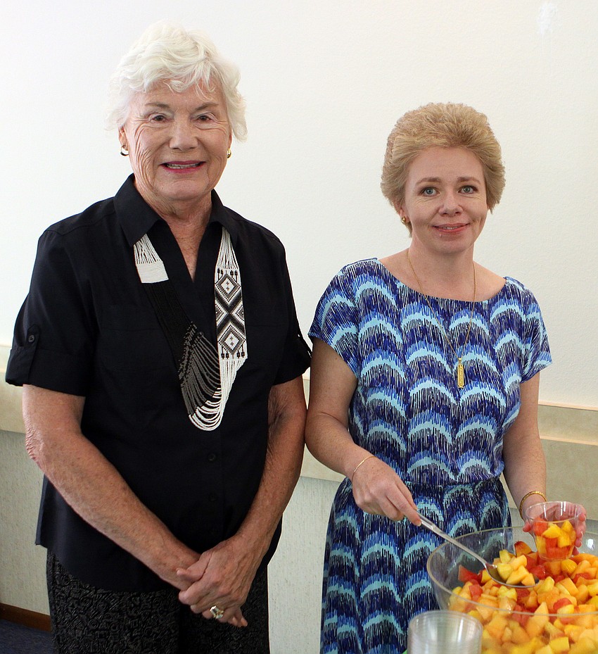 Ann Mumford stands next to Alison Jones while she makes fruit cups Sunday, June 5 during the All Angels brunch.