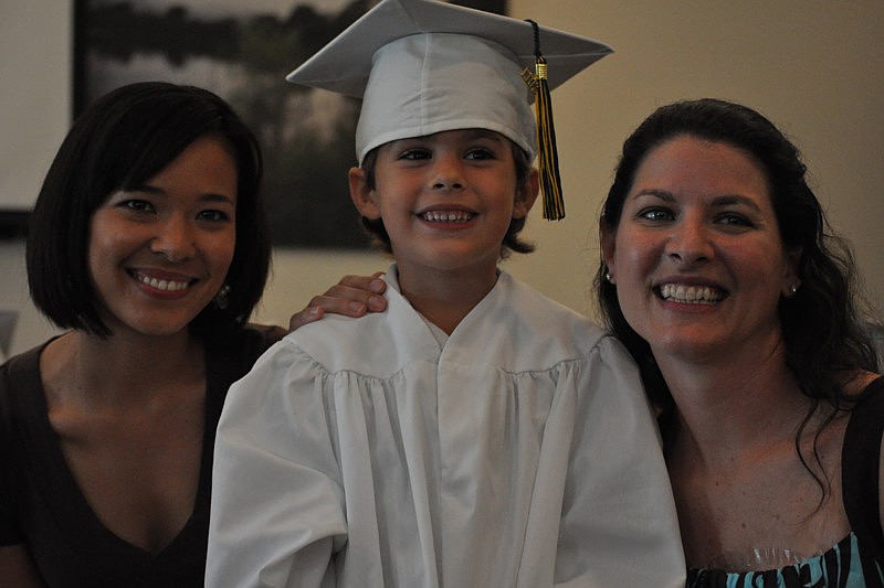 Graduate Drew Hill received his diplomas from his teachers, Jayna Armstrong, left, and Susan Artemik, right.