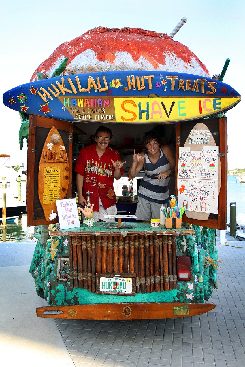 Juan Gutierrez and Christopher Kimpton pose in the Hukilau Hut Treats stand during the Sarasota Yacht Club's 1st ever Concert on the Lawn event Saturday, June 11 at the Sarasota Yacht Club.