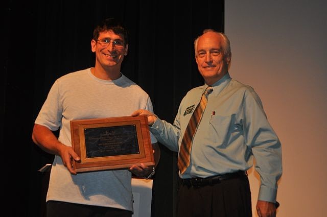 Petar Sibinkic, Your Fitness Instructor, accepts the '10 employees or fewer' category award from Dennis Hassell.