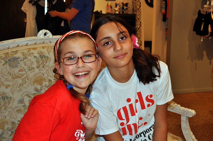 McLain Miller, 9, and Anna Verhelle, 11, pose together Saturday, June 25 inside Lotus.