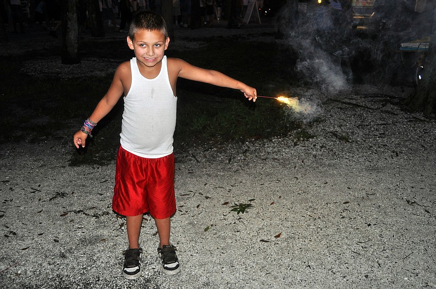Julian Eastman, 7, plays with a sparkler Monday, July 4 at Island Park.