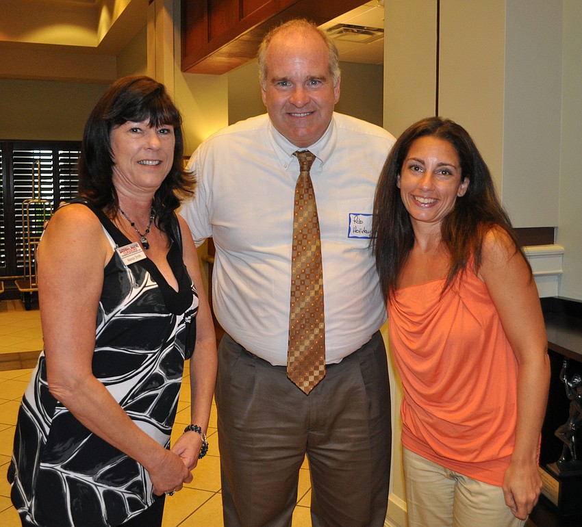 Wanda Smith of National Carpet Cleaning, Rob Ferguson of the Holiday Inn and Toni Artusa of Puroclean