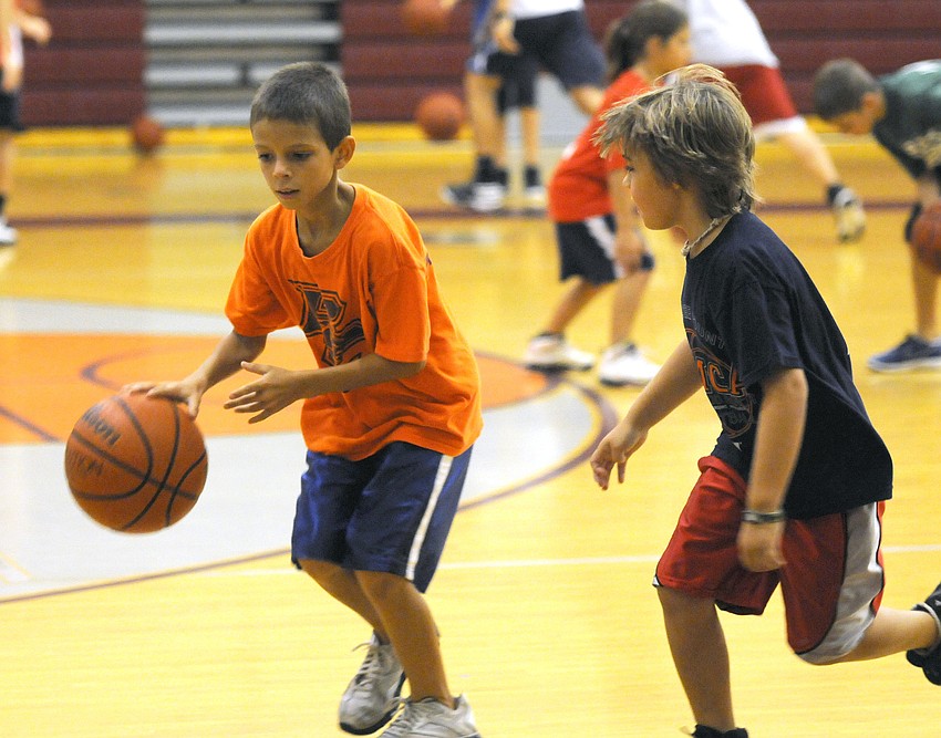 Fifth-grader Tristan VanTil attempts to dribble the ball around fourth-grader Garrett Murphy.