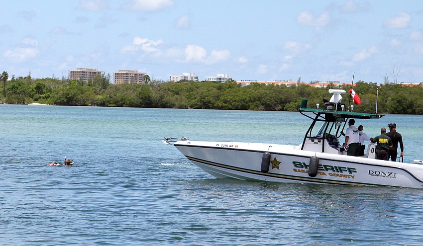 Deputy sheriffs Matt Binkley and Mike Watson make their way with the mannequin to the rescue boat as part of the mock marine search and rescue mission Thursday, July 21 at Ken Thompson Park Boat Ramp.