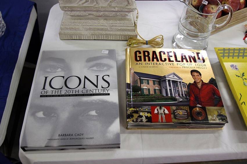 Some large coffee table books including â€œIconsâ€ and â€œGracelandâ€ were for sale Friday, July 22 at the estate sale.