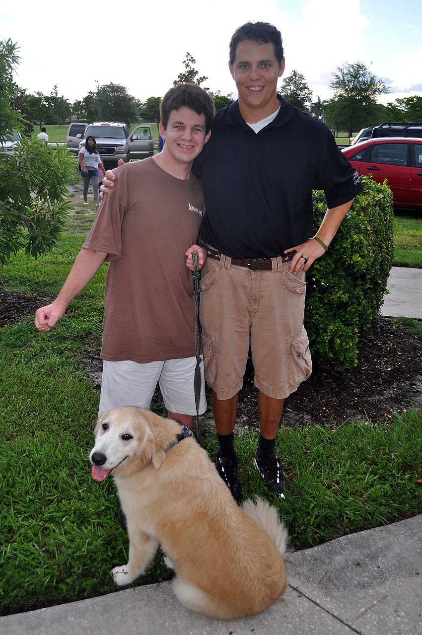 Matthew Griffin and Kelly Kirschner pose with Kirschner's dog, Luna, Thursday, July 28 during the Alta Vista neighborhood picnic at Payne Park.